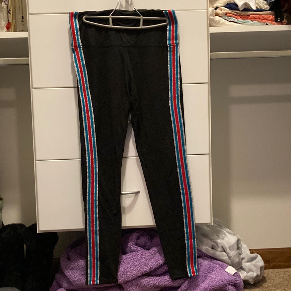 Black leggings with red, blue, and silver stripes down sides